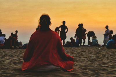 People at beach during sunset