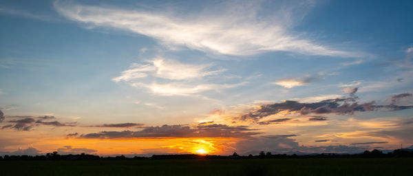 Scenic view of field against sky during sunset