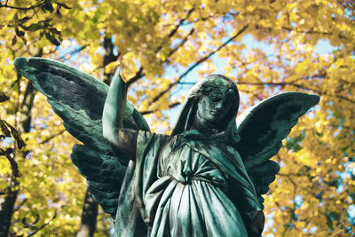 Low angle view of statue against trees