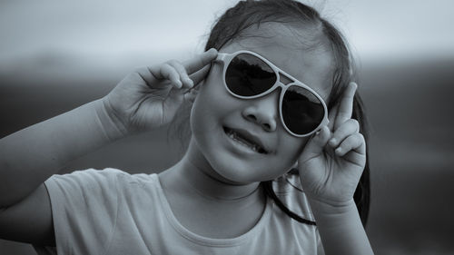 Portrait of smiling girl wearing sunglasses