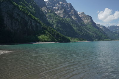 Scenic view of sea and mountains against sky