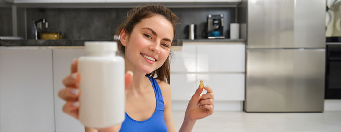 Portrait of young woman using mobile phone