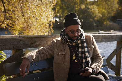 Man on bench using cell phone