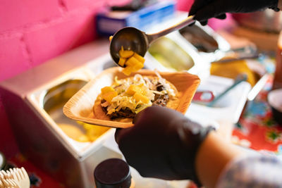 Cropped hand of person preparing food