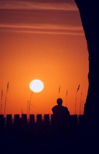 Silhouette of built structure at sunset