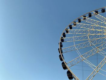 Low angle view of ferris wheel against clear sky