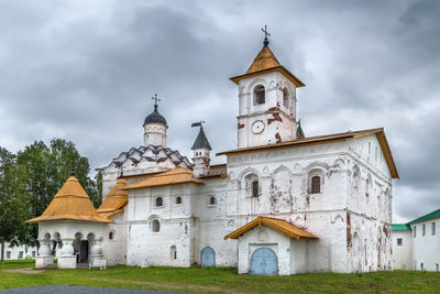 Church by building against sky