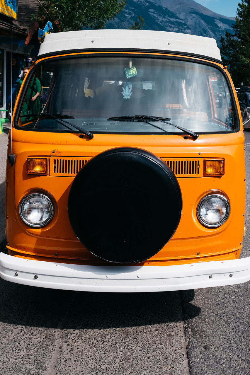 CLOSE-UP OF VINTAGE CAR ON ROAD