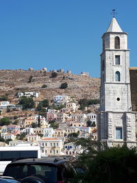 High angle view of buildings against clear blue sky