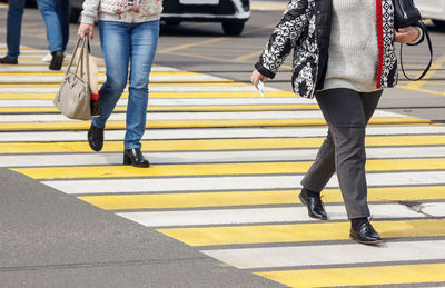 Low section of people walking on road