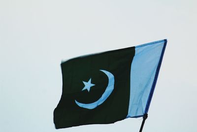 Low angle view of flag against white background