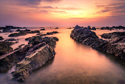 Scenic view of sea against romantic sky at sunset