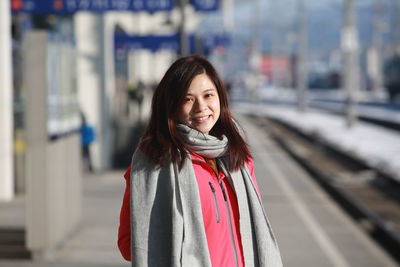 Portrait of smiling young woman standing outdoors