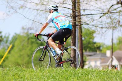 Man riding bicycle on field