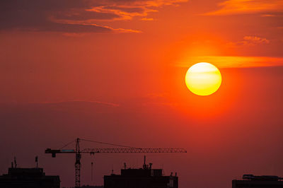 Silhouette of building against sky during sunset