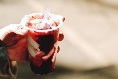 Close-up of hand holding drink