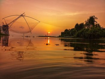 Scenic view of lake against orange sky