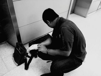 Side view of young man using mobile phone