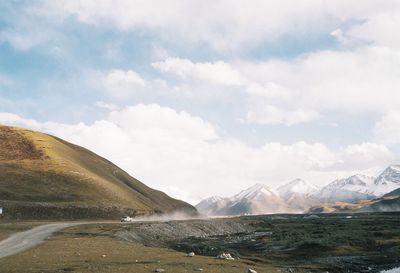 Scenic view of mountains against cloudy sky