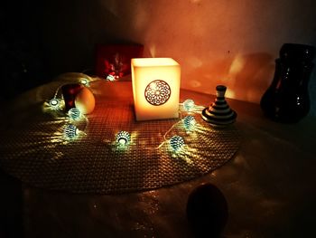 Close-up of illuminated lantern on table