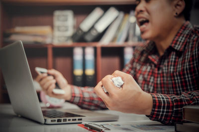 Midsection of man using mobile phone
