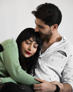 Side view of young woman sitting at home