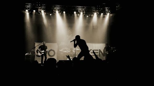 Silhouette of man with arms raised