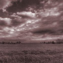 Scenic view of landscape against cloudy sky