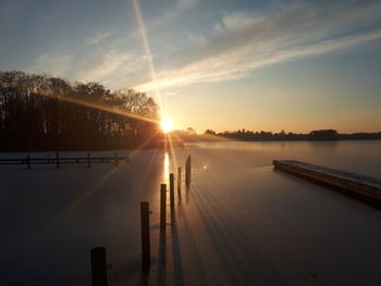 Scenic view of lake against sky during sunset