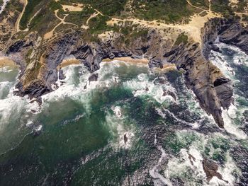 High angle view of stream flowing through rocks