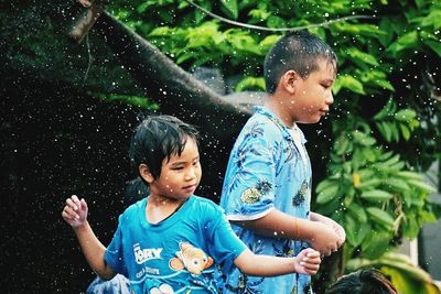 Happy friends in water at park