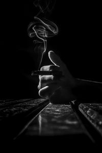 Close-up of hand holding black background