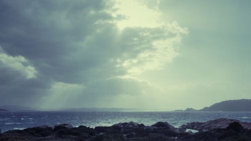 Scenic view of sea against cloudy sky