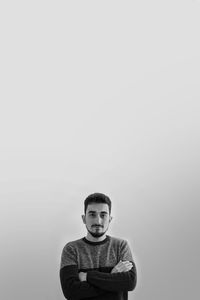 Portrait of boy standing against white background