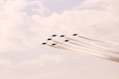 Low angle view of airplane flying against sky