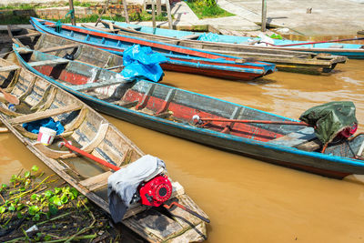 Wooden canoes moored on river