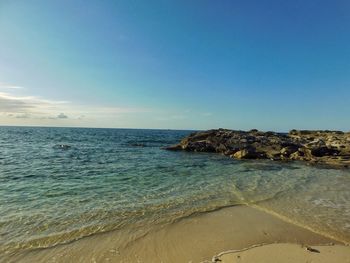 Scenic view of sea against clear blue sky