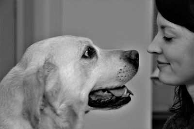 Close-up of woman with dog at home