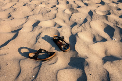 High angle view of shoes on sand