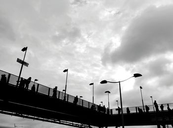 Low angle view of street light against cloudy sky