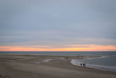 Scenic view of beach against sky during sunset