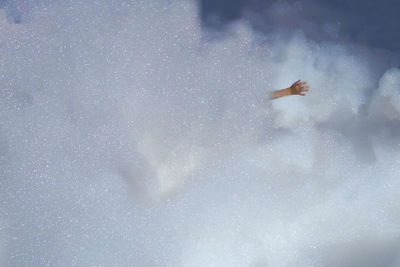 Woman swimming in water against sky