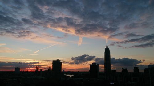 Silhouette cityscape against sky during sunset