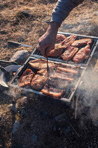 Close-up of preparing food on barbecue grill