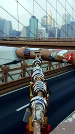 Low angle view of padlocks on bridge