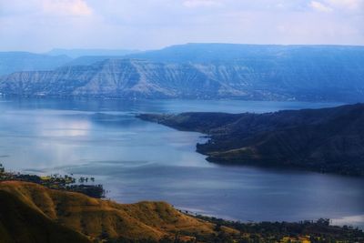 Scenic view of lake and mountains against sky