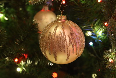 Close-up of christmas decorations hanging on tree