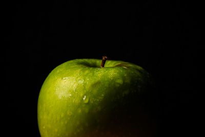 Close-up of apple against black background