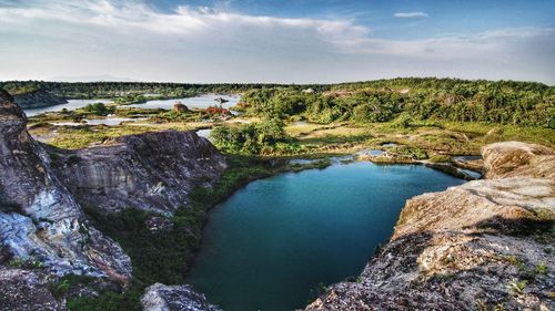 Scenic view of waterfall against sky