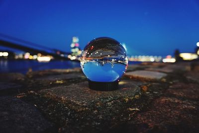 Close-up of crystal ball on rock at night
